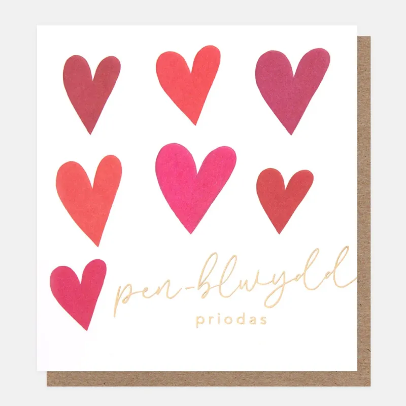 welsh language anniversary card featuring red & pink love hearts and the text pen-blwydd proidas